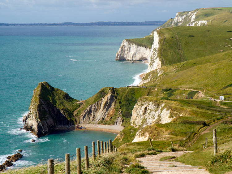 Coastal path on jagged cliffs overlooking beautiful turquoise sea