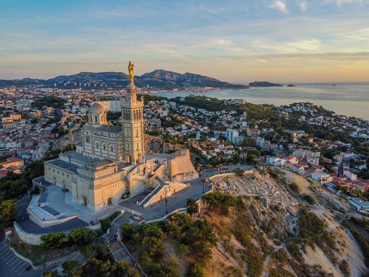 An aerial view of Marseille, with the Basilica of Notre-Dame de la Garde in the foreground