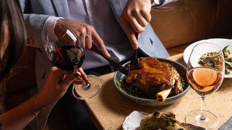 Man cutting into big piece of meat
